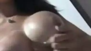 Beautiful girl massaging lovely boobs with lotion